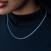 Collar de tenis de microdiamantes y topacio azul en oro blanco