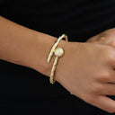 Pulsera rígida de oro amarillo con bola helada