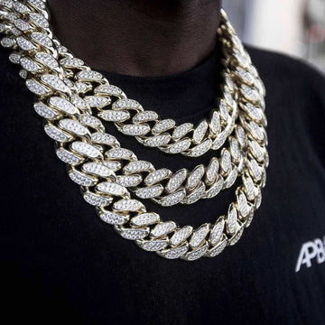 18” 20" and 22" Diamond Cuban Link Chokers (19mm) in yellow gold covered in hand set CZ stones worn together by a male model in a black t-shirt.