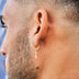 Aretes de aro redondos con cruz pulida en oro amarillo