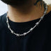 18” Iced Barbed Wire Necklace in white gold worn by a male model in a black t-shirt cropped to show jewelry. 